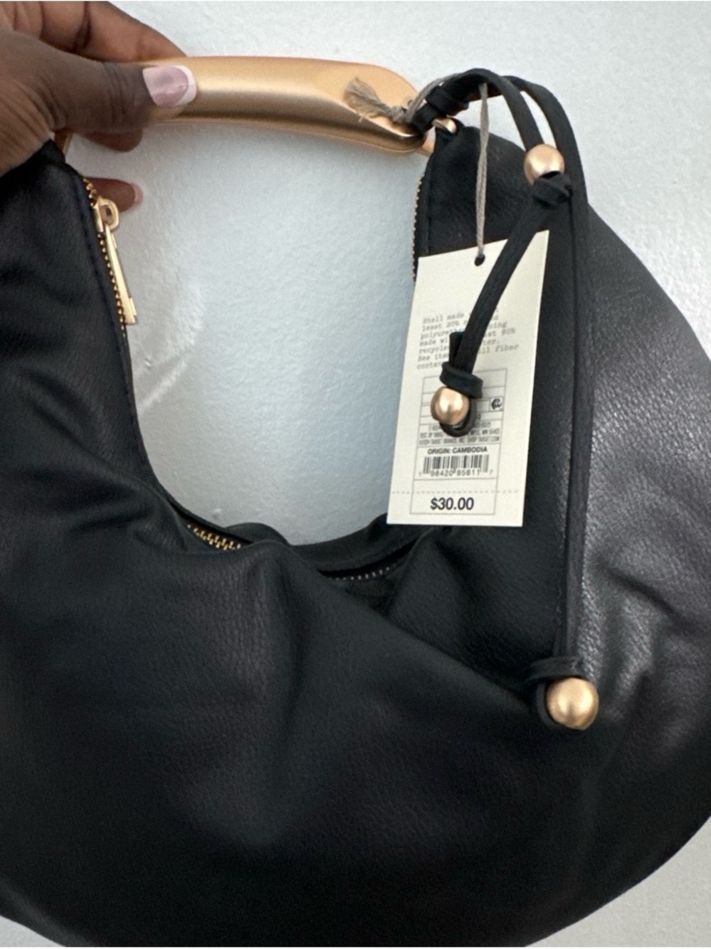 Sleek Black Hobo Bag with Gold Accent Handle